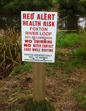 A sign warns against swimming in the Foxton Loop