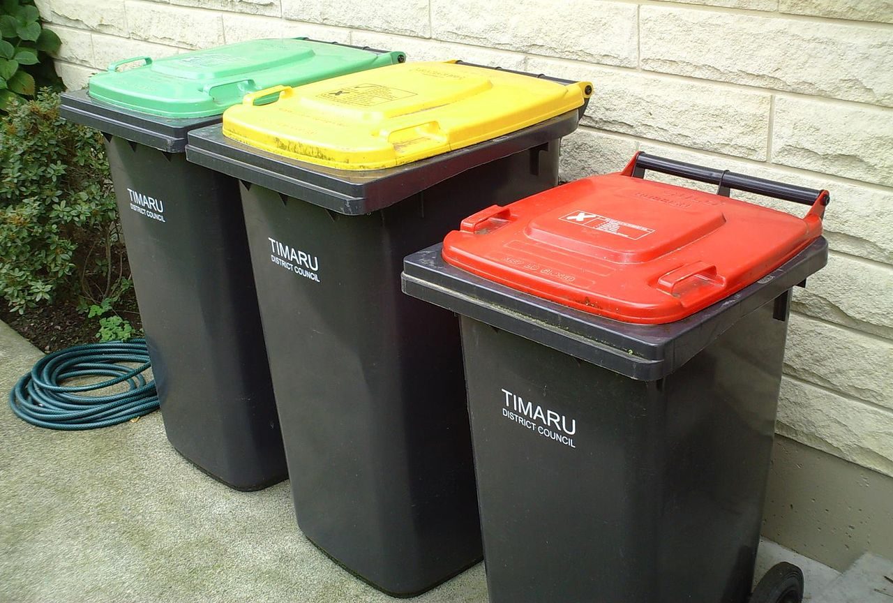 Three bins from Timaru District Council. Green for green waste, yellow for recycling and red for general waste.