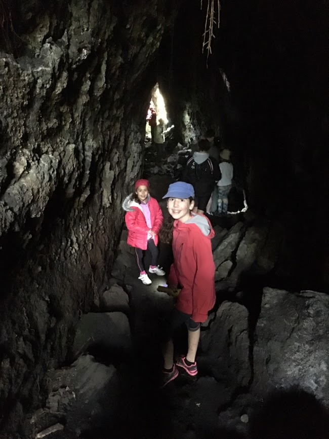 Exploring a cave on Rangitoto